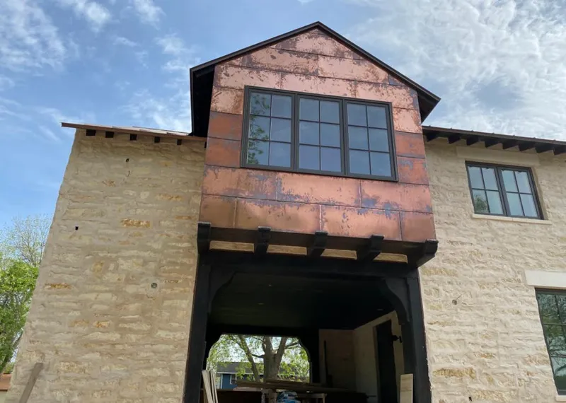 Copper metal panel facade on a stone building for Skylight Installation in Northlake